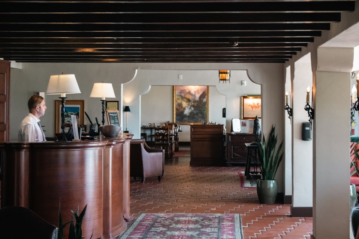Hotel reception with staff assisting a guest
